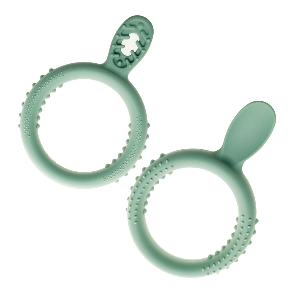 Two mint green TalkTools Itsy™ rings with textured surfaces and playful shapes for sensory exploration.