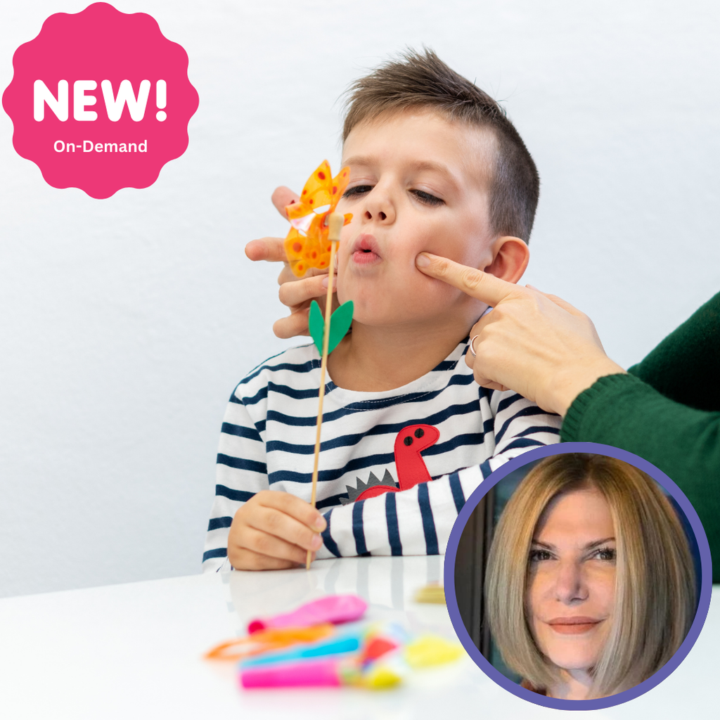 A child in a striped shirt practices articulation with an adult pointing at their mouth, surrounded by colorful materials.