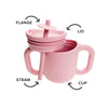TalkTools Itsy Cup in soft pink with a straw, lid, and flange, designed for baby and toddler use.