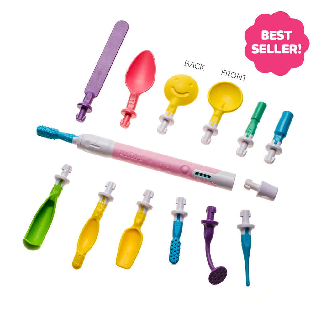 Twelve colorful plastic interchangeable tips and a pink TalkTools Sensi tool handle arranged on a white background.